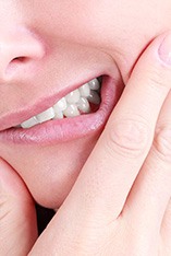 Close-up of woman with tooth pain in need of emergency dentist in Park Slope, NY