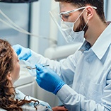 Dentist examining patient's teeth