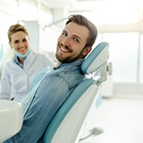 Man smiling while sitting in treatment chair