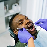 Dentist examining patient's teeth