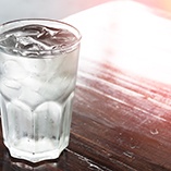 Glass of ice water on wood table