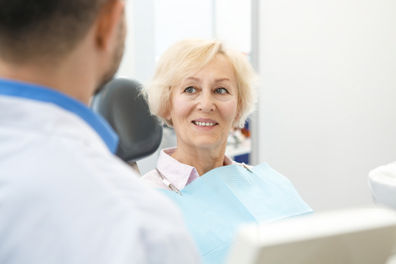 patient smiling while looking at dentist 